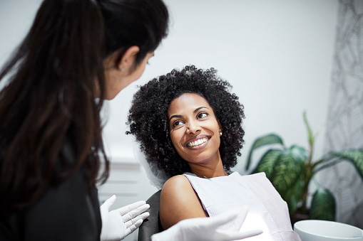  Dentist discussing tooth loss with smiling female patient at Fairmount Dental Center in Salem, OR 97302-4310